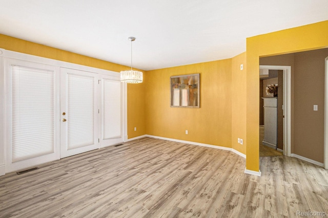 5103 Coachlight Dr, Fenton, MI 48430 - unfurnished dining area featuring light wood-type flooring and a chandelier