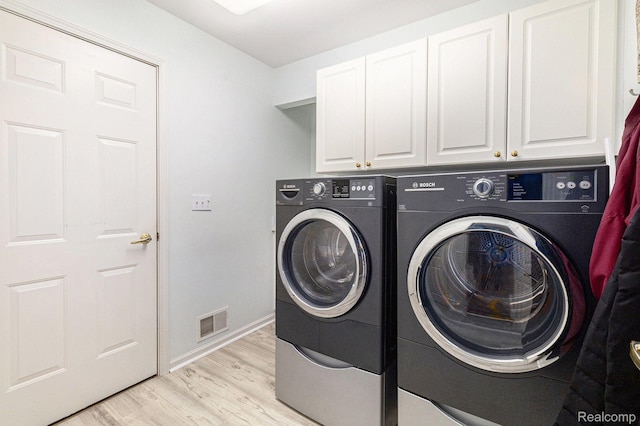 5103 Coachlight Dr, Fenton, MI 48430 - washroom with washer and dryer, cabinet space, and light wood finished floors
