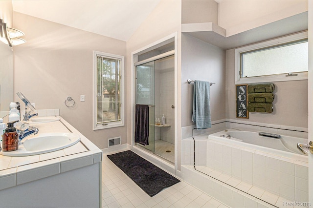 5103 Coachlight Dr, Fenton, MI 48430 - bathroom featuring tile patterned flooring, a bath, a shower stall, vaulted ceiling, and double vanity