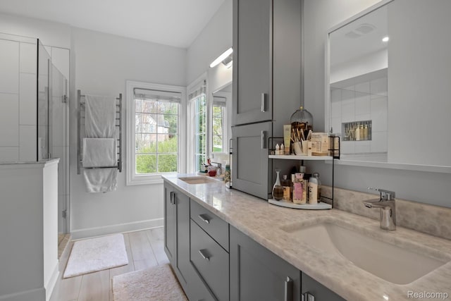 900 Mcdonald Dr, Northville, MI 48167 - full bath with double vanity, a stall shower, and wood finished floors