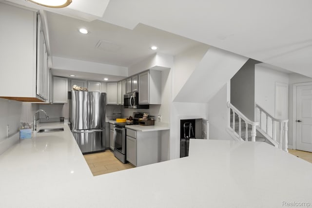900 Mcdonald Dr, Northville, MI 48167 - kitchen with appliances with stainless steel finishes, gray cabinets, light countertops, recessed lighting, and light wood-type flooring