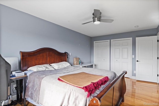 900 Mcdonald Dr, Northville, MI 48167 - bedroom featuring two closets, wood finished floors, and ceiling fan