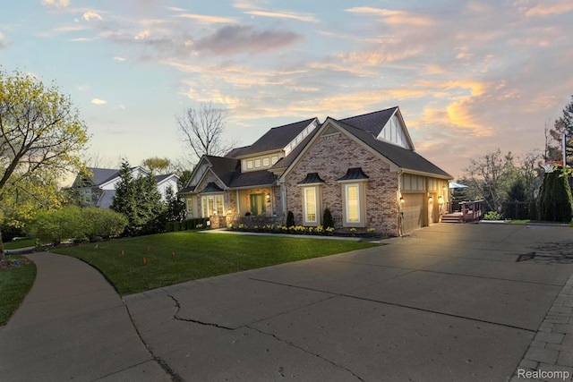 900 Mcdonald Dr, Northville, MI 48167 - view of front facade featuring brick siding, a yard, concrete driveway, and a garage