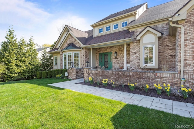 900 Mcdonald Dr, Northville, MI 48167 - view of front facade featuring a front lawn, brick siding, and roof with shingles