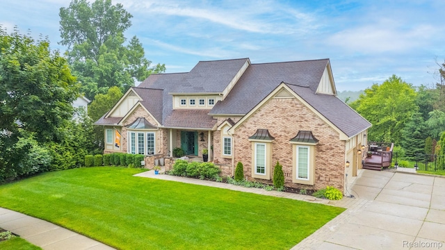 900 Mcdonald Dr, Northville, MI 48167 - craftsman-style house featuring concrete driveway, a front lawn, a shingled roof, and brick siding