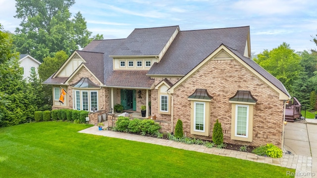 900 Mcdonald Dr, Northville, MI 48167 - view of front of house with brick siding, a front lawn, and a shingled roof