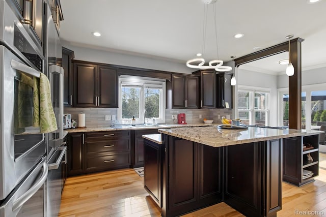 900 Mcdonald Dr, Northville, MI 48167 - kitchen featuring plenty of natural light, ornamental molding, a center island, tasteful backsplash, and recessed lighting