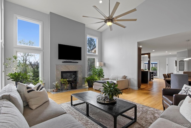900 Mcdonald Dr, Northville, MI 48167 - living area featuring a high ceiling, ceiling fan, a fireplace, light wood-style flooring, and recessed lighting