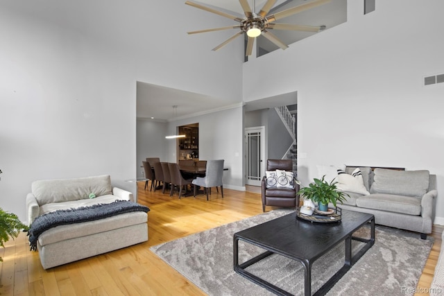 900 Mcdonald Dr, Northville, MI 48167 - living room featuring stairway, ceiling fan, a towering ceiling, and wood finished floors