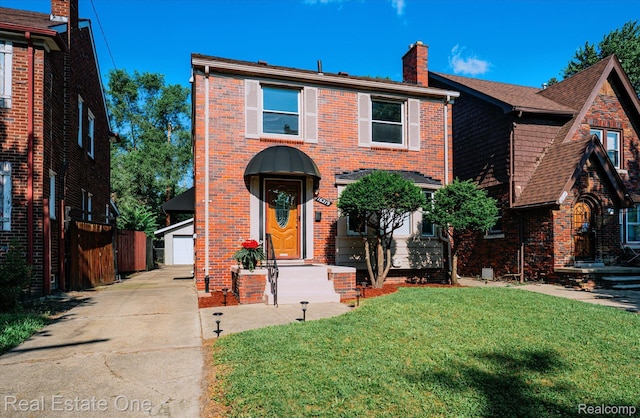 16219 Normandy St, Detroit, MI 48221 - view of front of property featuring a chimney, an outdoor structure, brick siding, and a garage