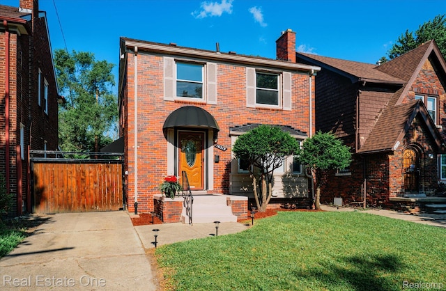 16219 Normandy St, Detroit, MI 48221 - view of front of property with a chimney, brick siding, and a gate