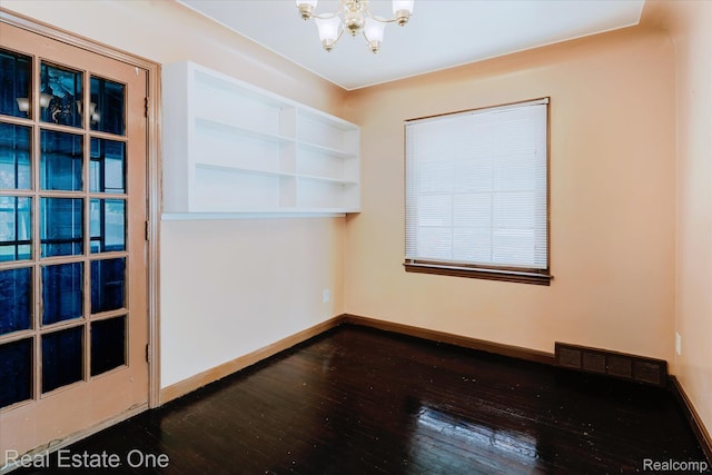 16219 Normandy St, Detroit, MI 48221 - empty room featuring a chandelier and dark wood-style flooring
