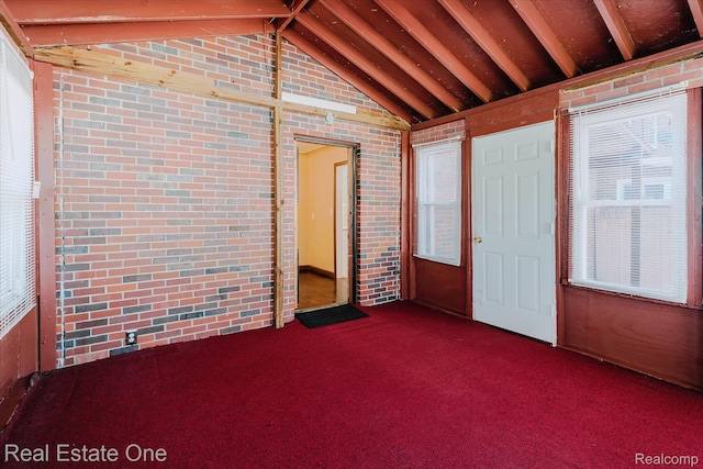 16219 Normandy St, Detroit, MI 48221 - empty room with brick wall, lofted ceiling, and carpet