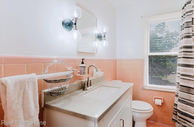 16219 Normandy St, Detroit, MI 48221 - bathroom featuring tile walls, vanity, and a wainscoted wall
