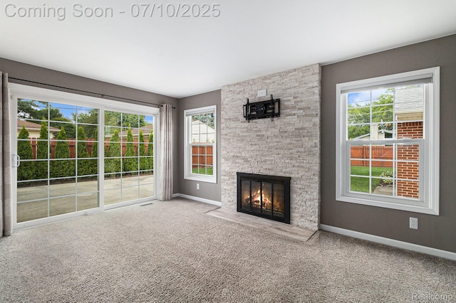 39408 Atkinson Dr, Sterling Heights, MI 48313 - unfurnished living room featuring a stone fireplace and carpet flooring
