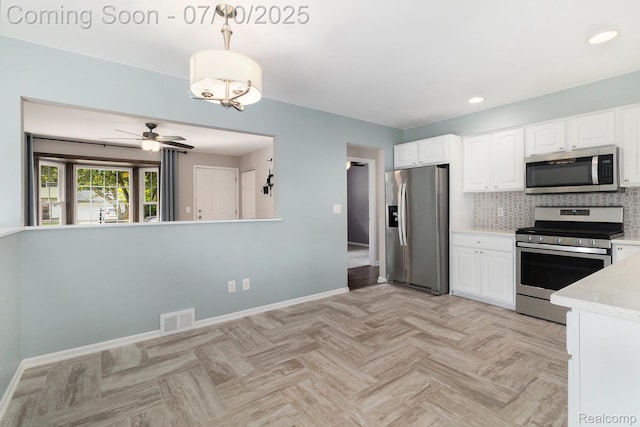 39408 Atkinson Dr, Sterling Heights, MI 48313 - kitchen with appliances with stainless steel finishes, white cabinets, hanging light fixtures, decorative backsplash, and recessed lighting