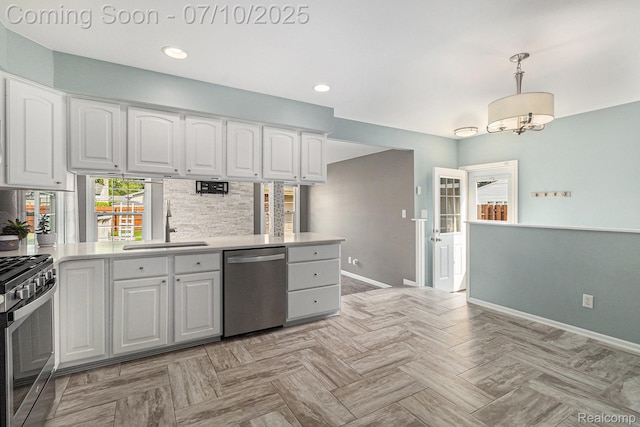 39408 Atkinson Dr, Sterling Heights, MI 48313 - kitchen with appliances with stainless steel finishes, light countertops, white cabinetry, hanging light fixtures, and backsplash