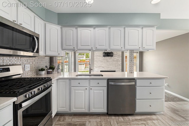 39408 Atkinson Dr, Sterling Heights, MI 48313 - kitchen with appliances with stainless steel finishes, backsplash, light countertops, and white cabinets