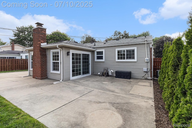 39408 Atkinson Dr, Sterling Heights, MI 48313 - back of property featuring a patio area and a chimney