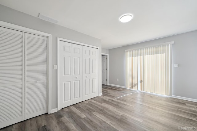 2245 Spring Hill Ave, Inkster, MI 48141 - unfurnished bedroom with two closets and wood finished floors