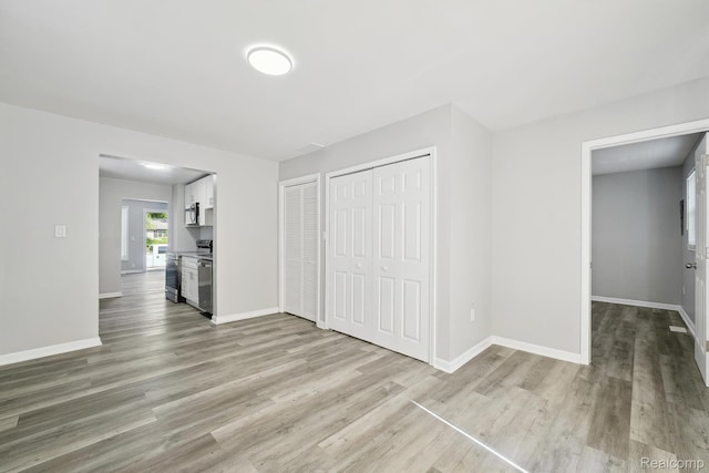 2245 Spring Hill Ave, Inkster, MI 48141 - unfurnished living room featuring wood finished floors and baseboards