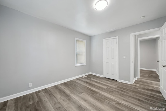 2245 Spring Hill Ave, Inkster, MI 48141 - unfurnished bedroom featuring wood finished floors and baseboards