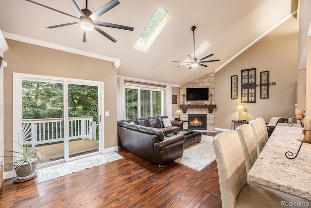 9780 Oak Valley Dr, Clarkston, MI 48348 - living room with a ceiling fan, a stone fireplace, dark wood-style flooring, plenty of natural light, and ornamental molding
