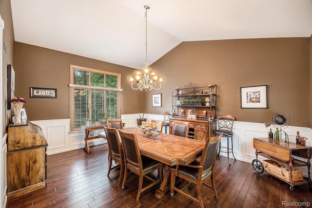 9780 Oak Valley Dr, Clarkston, MI 48348 - dining space with wainscoting, a chandelier, vaulted ceiling, dark wood-type flooring, and a decorative wall