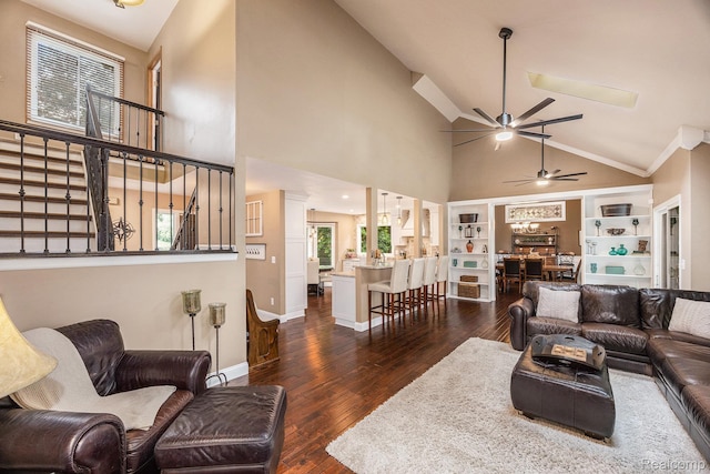 9780 Oak Valley Dr, Clarkston, MI 48348 - living room with high vaulted ceiling, a ceiling fan, stairs, dark wood-style floors, and built in features