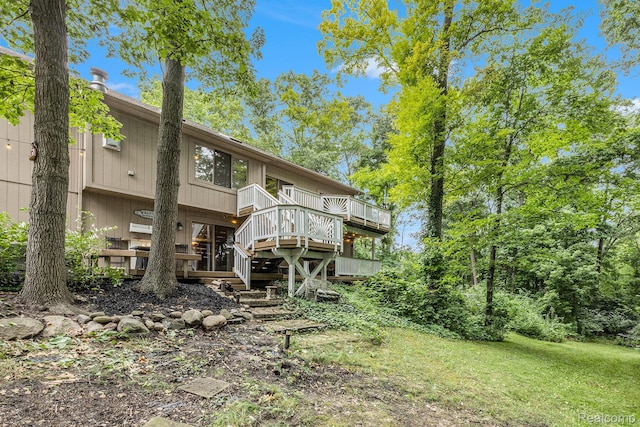 9780 Oak Valley Dr, Clarkston, MI 48348 - rear view of property with a wooden deck and stairway