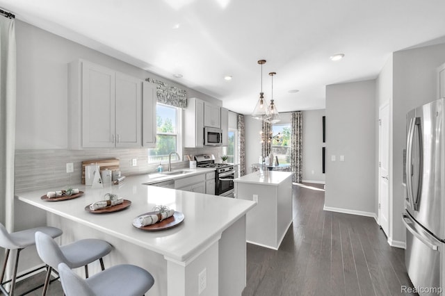 2768 Silo Dr, Saline, MI 48176 - kitchen featuring stainless steel appliances, a center island, plenty of natural light, recessed lighting, and decorative backsplash