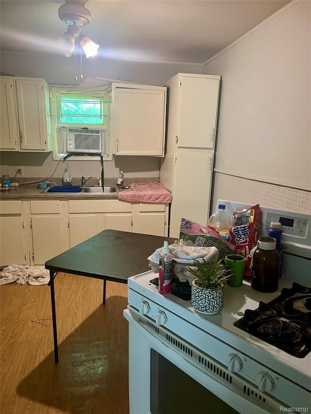 302 W Gracelawn Ave, Flint, MI 48505 - kitchen with white gas range, white cabinetry, and cooling unit
