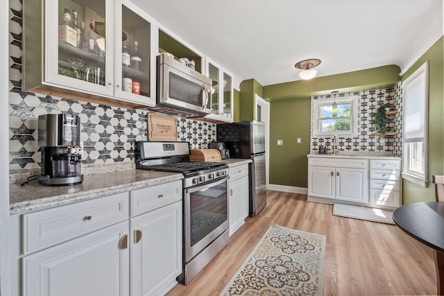 352 W Tacoma St, Clawson, MI 48017 - kitchen with appliances with stainless steel finishes, white cabinetry, and decorative backsplash