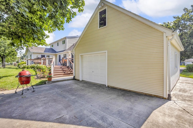 3416 Northlands Ave, Jackson, MI 49201 - view of home's exterior featuring concrete driveway, a deck, a garage, and stairs
