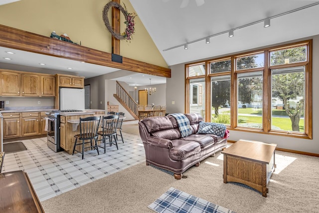 3416 Northlands Ave, Jackson, MI 49201 - living room featuring track lighting, light colored carpet, a chandelier, high vaulted ceiling, and stairway