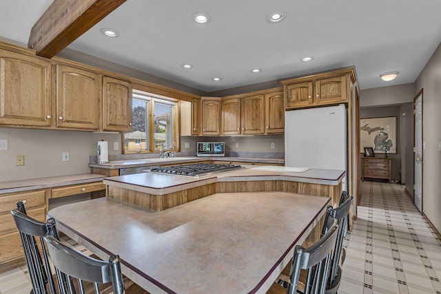 3416 Northlands Ave, Jackson, MI 49201 - kitchen featuring a center island, stainless steel gas cooktop, light countertops, recessed lighting, and light flooring