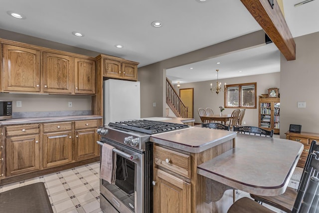 3416 Northlands Ave, Jackson, MI 49201 - kitchen featuring stainless steel stove, freestanding refrigerator, recessed lighting, brown cabinetry, and a chandelier