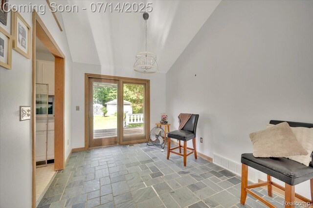 3117 Maumee Trl, Clyde, MI 48049 - living area featuring stone tile floors and high vaulted ceiling