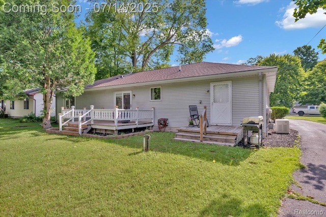 3117 Maumee Trl, Clyde, MI 48049 - back of property with a wooden deck, a yard, and roof with shingles