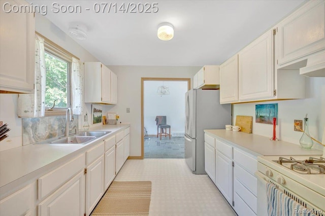 3117 Maumee Trl, Clyde, MI 48049 - kitchen with light countertops, freestanding refrigerator, white cabinetry, white range with gas stovetop, and light flooring