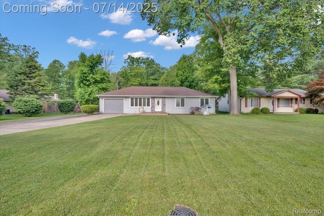 3117 Maumee Trl, Clyde, MI 48049 - ranch-style house with concrete driveway, a garage, and a front yard