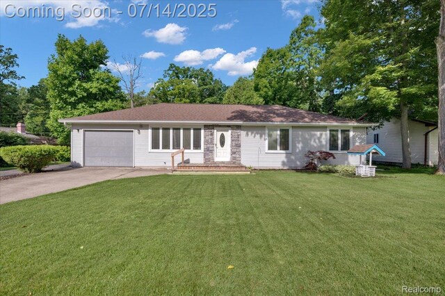 3117 Maumee Trl, Clyde, MI 48049 - ranch-style home with driveway, a front yard, and a garage