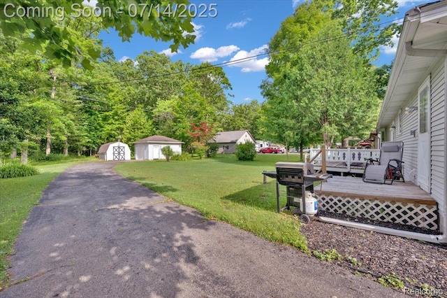 3117 Maumee Trl, Clyde, MI 48049 - view of grassy yard with a storage shed and a wooden deck