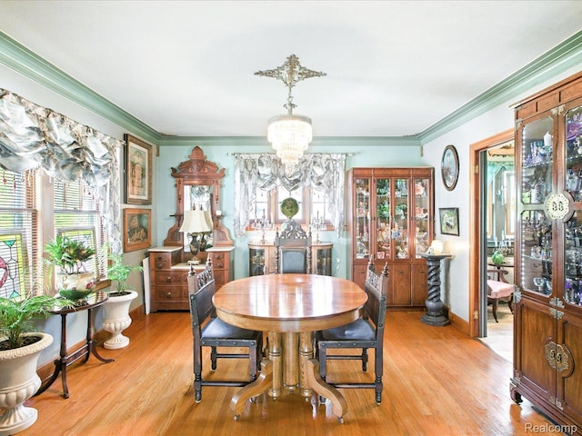 1313 Wall St, Port Huron, MI 48060 - dining area with a chandelier, ornamental molding, healthy amount of natural light, and light wood-type flooring