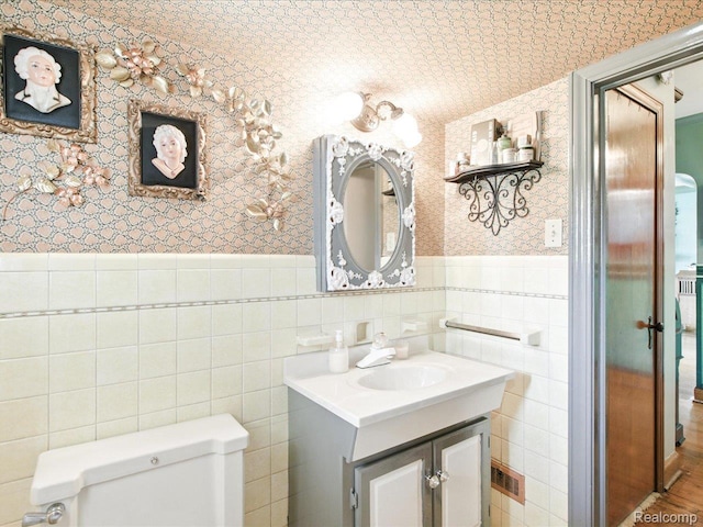 1313 Wall St, Port Huron, MI 48060 - half bathroom featuring wallpapered walls, vanity, wainscoting, and tile walls