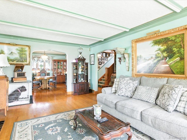 1313 Wall St, Port Huron, MI 48060 - living area featuring arched walkways, wood finished floors, stairway, and beamed ceiling