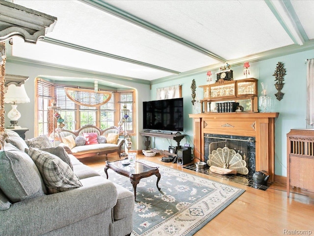 1313 Wall St, Port Huron, MI 48060 - living area featuring wood finished floors, a fireplace with flush hearth, and crown molding