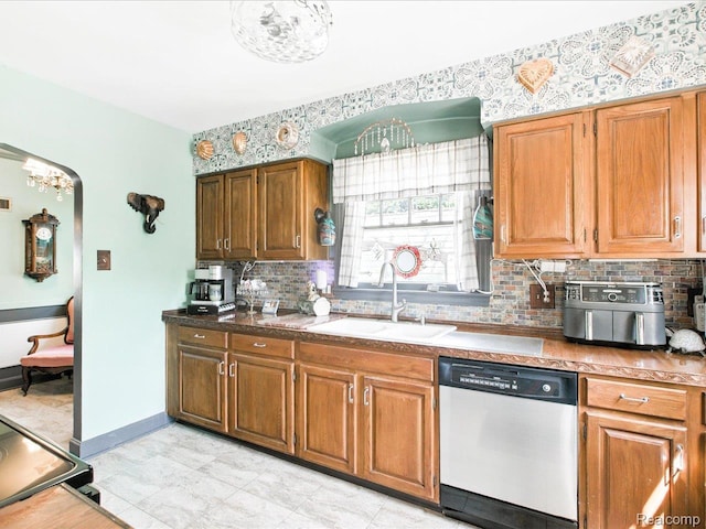 1313 Wall St, Port Huron, MI 48060 - kitchen featuring dishwasher, brown cabinetry, backsplash, stove, and arched walkways