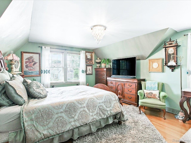 1313 Wall St, Port Huron, MI 48060 - bedroom featuring lofted ceiling, wood finished floors, and a chandelier