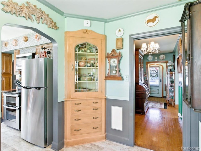 1313 Wall St, Port Huron, MI 48060 - kitchen with appliances with stainless steel finishes, ornamental molding, and a chandelier